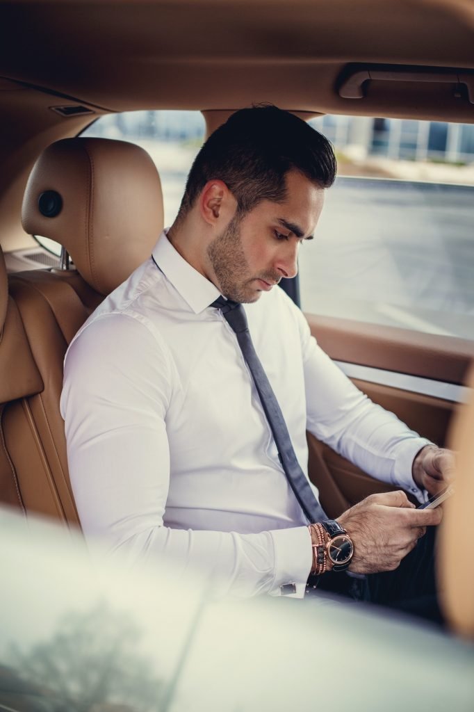 Stylish male in a white shirt using smartphone.